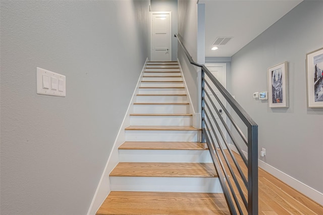 stairway featuring hardwood / wood-style flooring