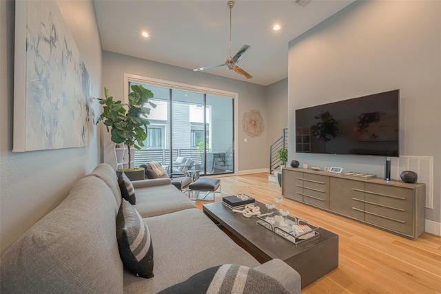 living room with ceiling fan and hardwood / wood-style floors