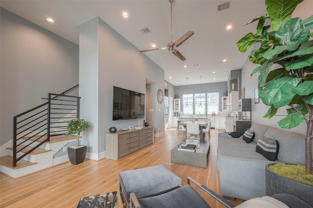 living room featuring ceiling fan and light wood-type flooring