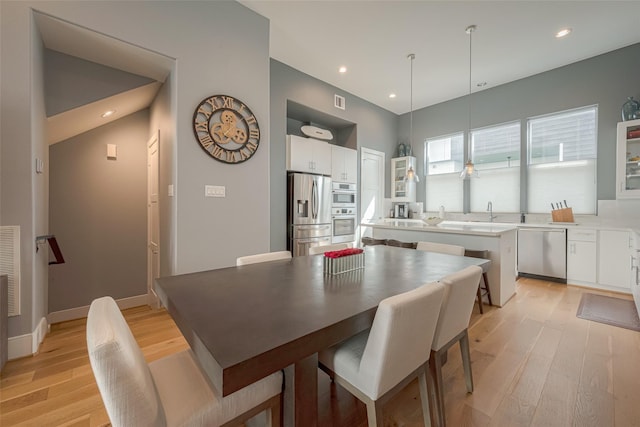 dining space with light hardwood / wood-style flooring