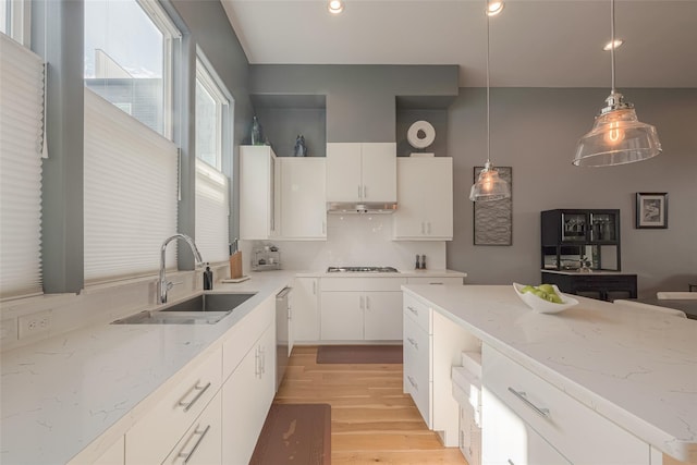 kitchen featuring pendant lighting, sink, white cabinetry, and appliances with stainless steel finishes