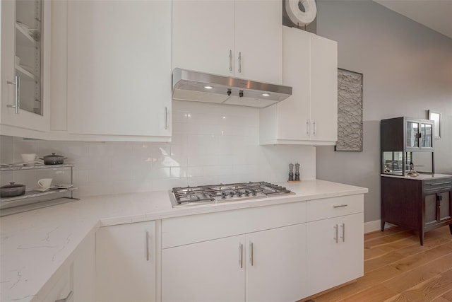 kitchen with white cabinetry, light stone counters, and stainless steel gas cooktop