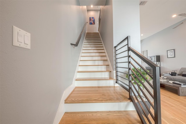 stairs with hardwood / wood-style floors