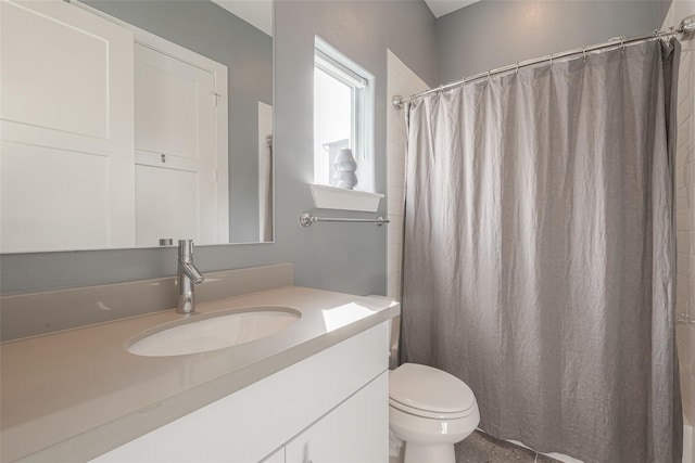 bathroom featuring vanity, toilet, and curtained shower