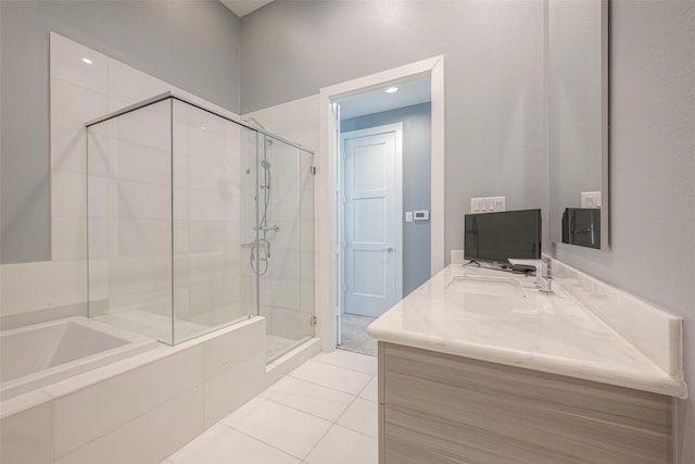 bathroom with tile patterned floors, vanity, and independent shower and bath