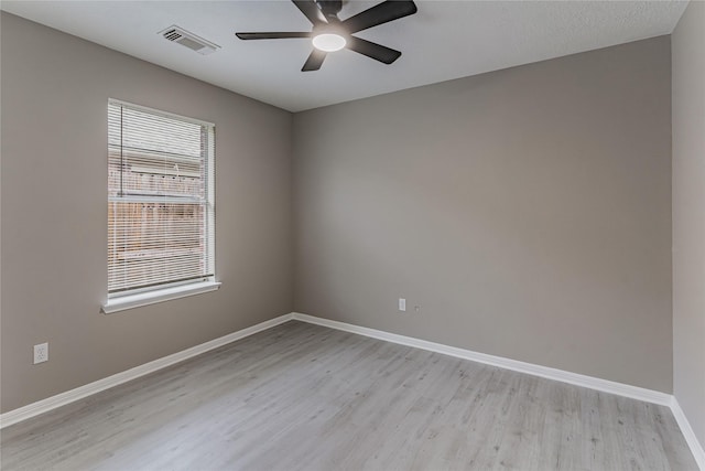 empty room with ceiling fan and light wood-type flooring