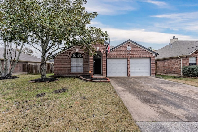 view of front of property featuring a garage and a front yard