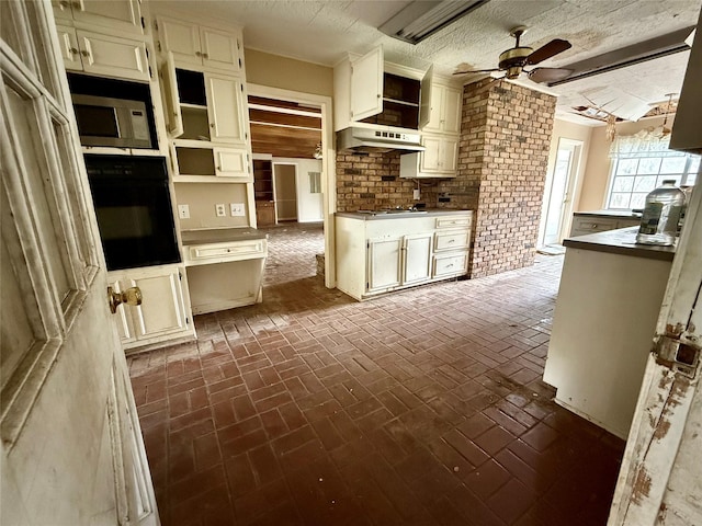 kitchen featuring open shelves, stainless steel microwave, a ceiling fan, black oven, and under cabinet range hood