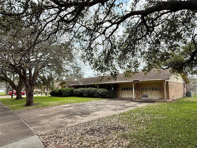 ranch-style house featuring a garage, driveway, central AC unit, a front yard, and brick siding