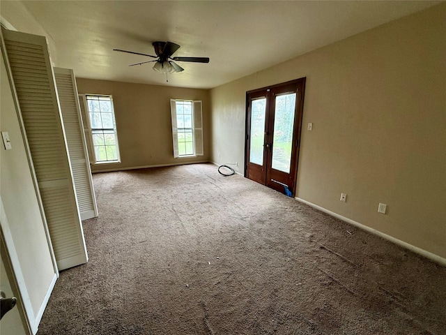 unfurnished room with carpet, baseboards, and french doors