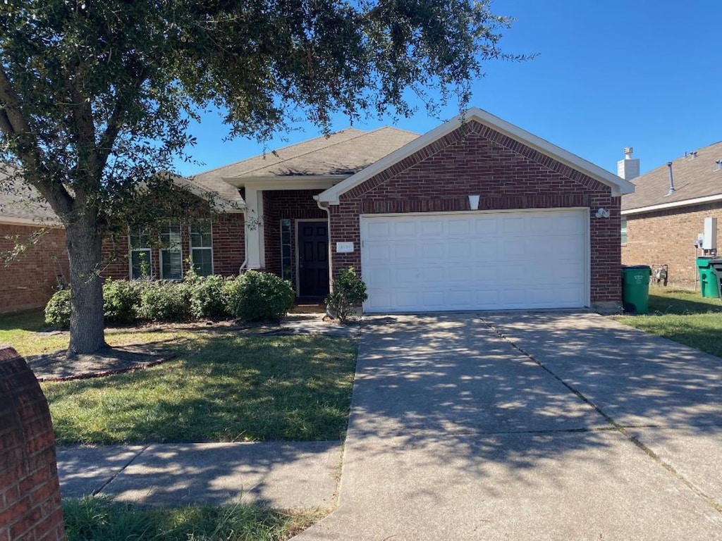 ranch-style house with a garage and a front yard