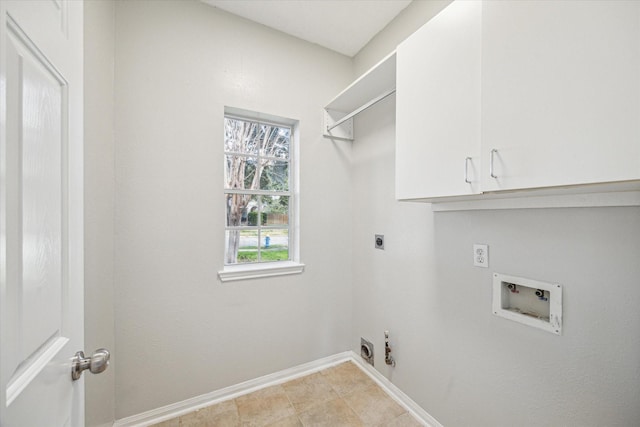 clothes washing area with hookup for a washing machine, hookup for an electric dryer, cabinets, and light tile patterned floors