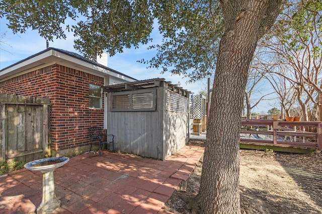 view of patio with an outbuilding and a deck