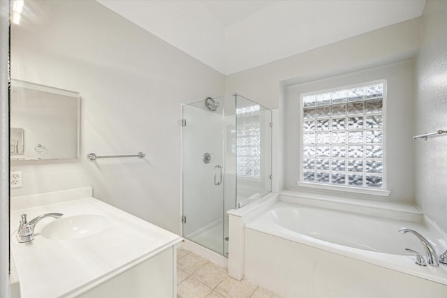 bathroom with tile patterned flooring, vanity, a healthy amount of sunlight, and separate shower and tub