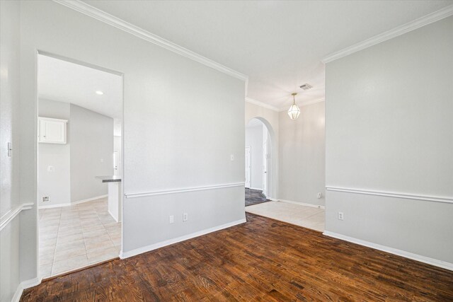 unfurnished room with hardwood / wood-style floors and crown molding