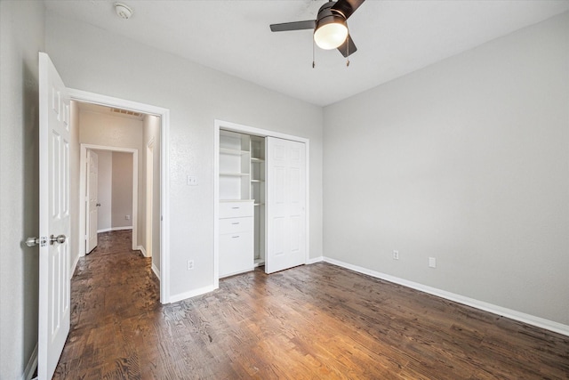 unfurnished bedroom featuring ceiling fan, dark hardwood / wood-style flooring, and a closet