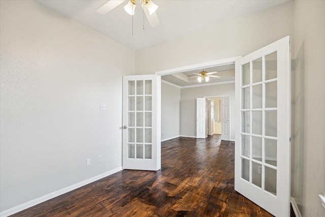 unfurnished room featuring a raised ceiling, dark hardwood / wood-style floors, french doors, and ceiling fan