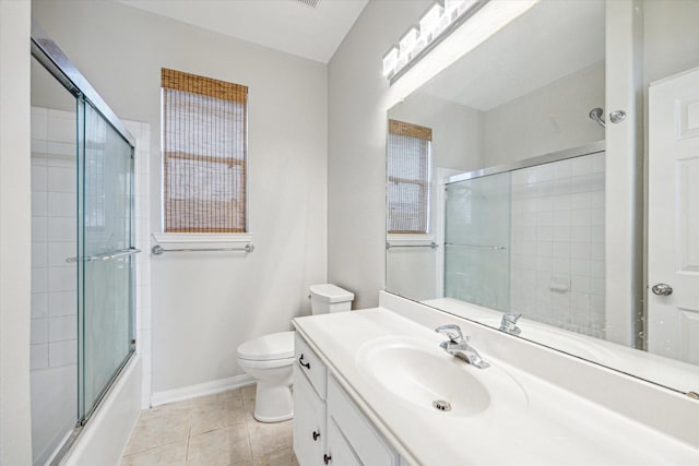 full bathroom featuring tile patterned flooring, vanity, combined bath / shower with glass door, and toilet