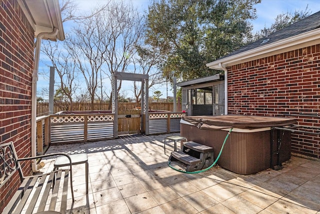 view of patio / terrace with a hot tub