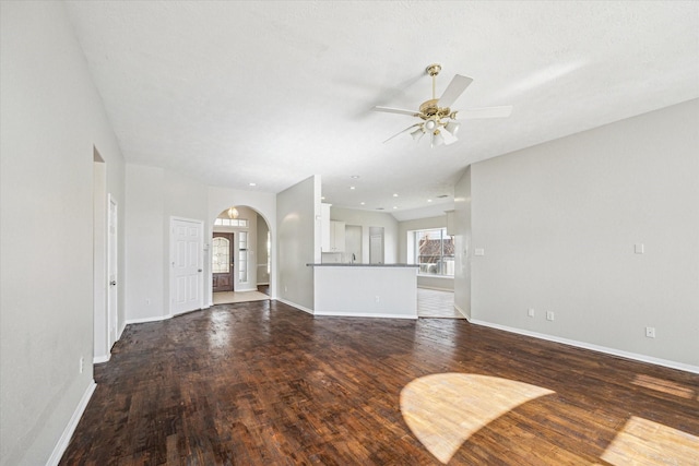 unfurnished living room featuring dark hardwood / wood-style floors and ceiling fan