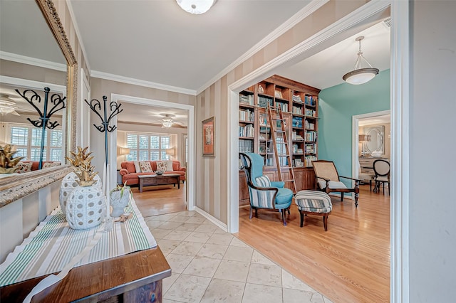 living area featuring ceiling fan, ornamental molding, and light hardwood / wood-style floors