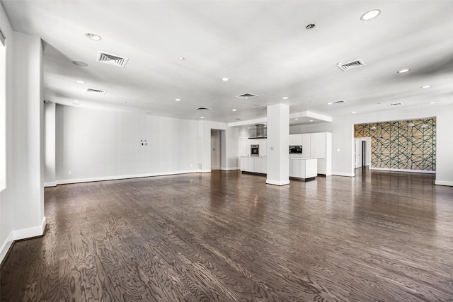 unfurnished living room featuring dark wood-type flooring