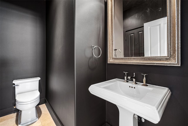 bathroom featuring tile patterned flooring, sink, and toilet