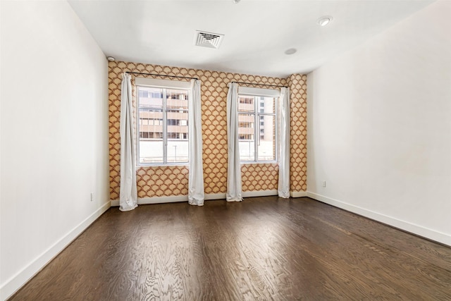 unfurnished room featuring dark wood-type flooring