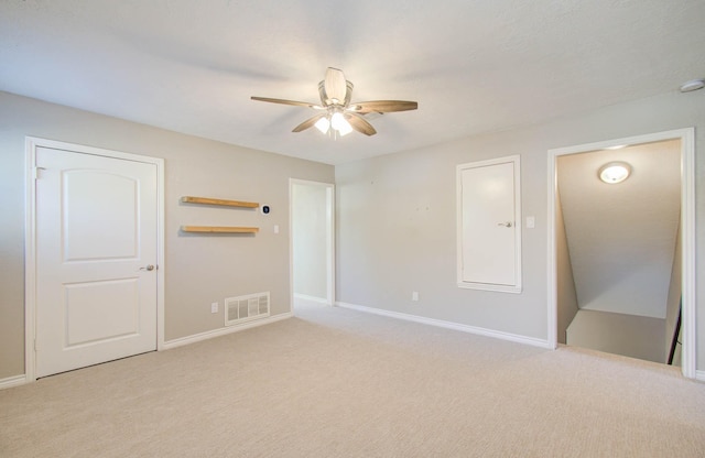 carpeted empty room featuring ceiling fan