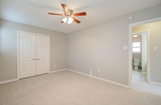 unfurnished bedroom with ceiling fan, a closet, and light carpet