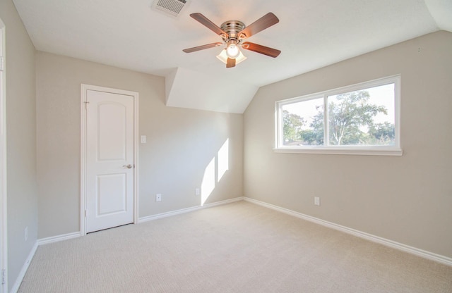 additional living space featuring lofted ceiling, light colored carpet, and ceiling fan