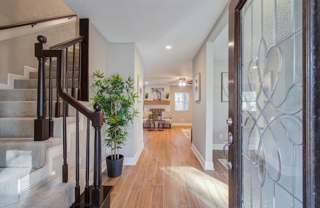 foyer entrance featuring ceiling fan and light hardwood / wood-style flooring