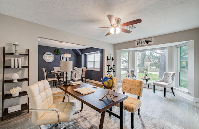 office area featuring hardwood / wood-style flooring, ceiling fan, and a textured ceiling