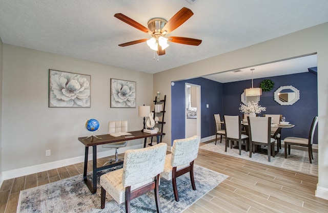 home office featuring ceiling fan and a textured ceiling