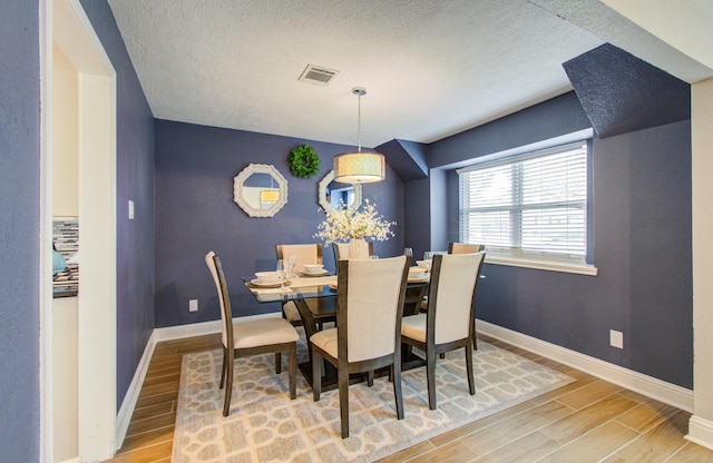 dining room featuring a textured ceiling