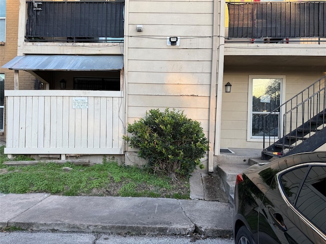 view of exterior entry featuring a balcony