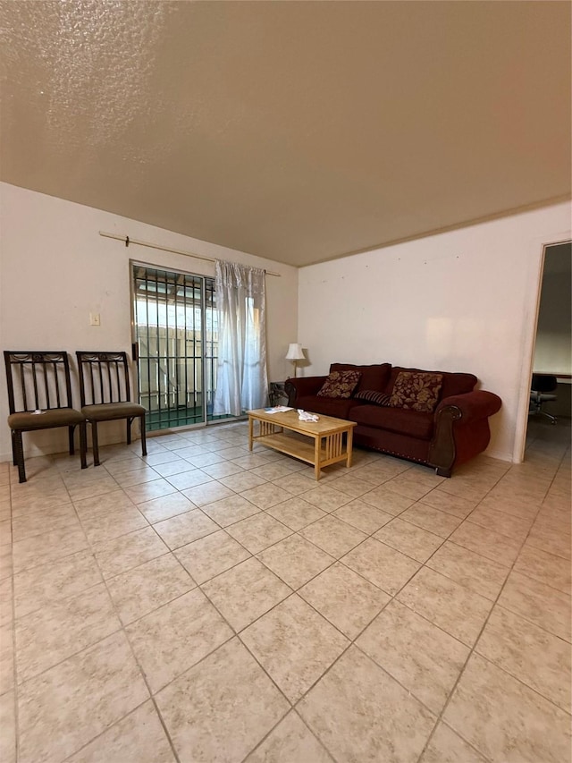 living room featuring light tile patterned floors and a textured ceiling