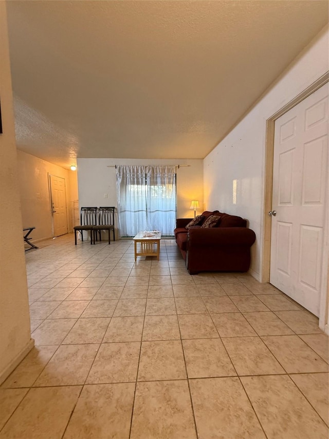 living room with light tile patterned flooring and a textured ceiling