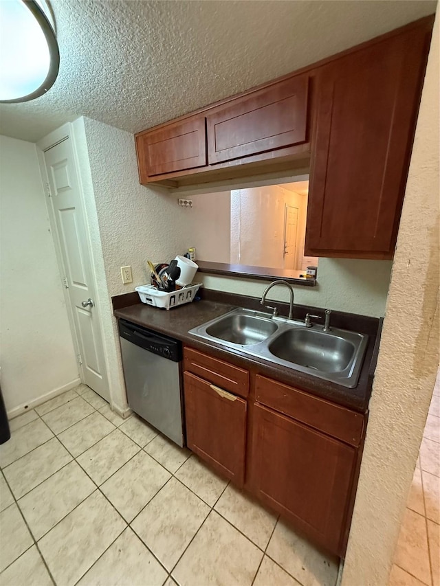 kitchen featuring sink, a textured ceiling, light tile patterned floors, and dishwasher