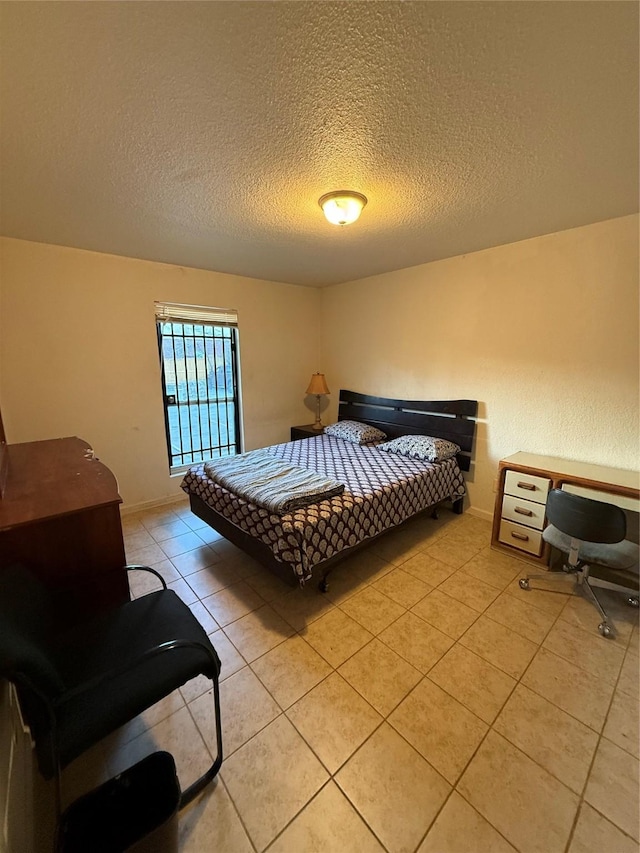 tiled bedroom featuring a textured ceiling