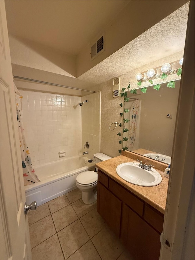 full bathroom featuring vanity, toilet, tile patterned floors, a textured ceiling, and shower / bath combo with shower curtain