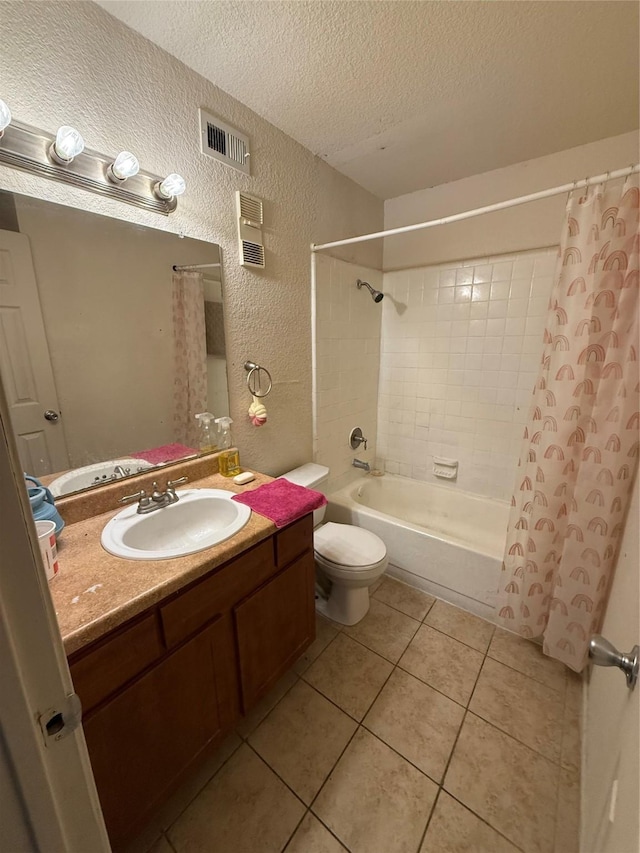 full bathroom with vanity, toilet, shower / bath combo, tile patterned floors, and a textured ceiling