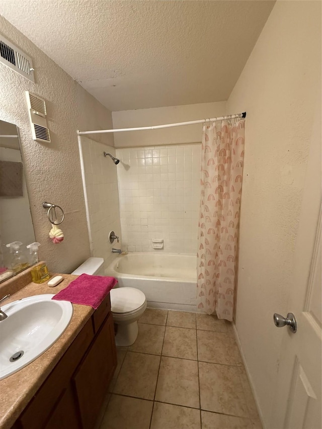 full bathroom featuring toilet, a textured ceiling, vanity, shower / bath combo, and tile patterned flooring