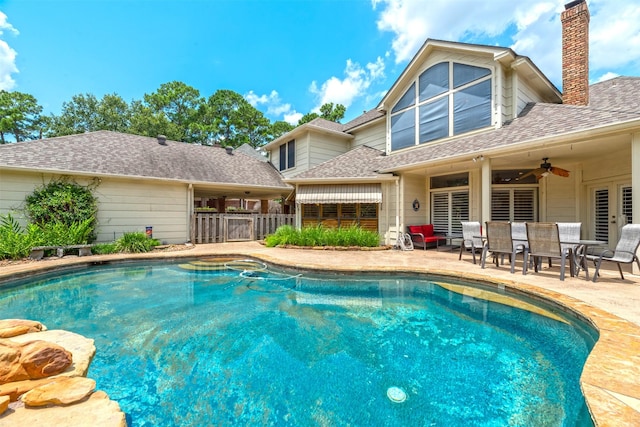 view of swimming pool featuring ceiling fan and a patio area