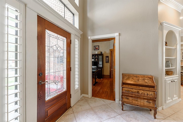 tiled foyer entrance with a high ceiling