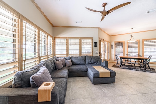 living room with light tile patterned floors, crown molding, and ceiling fan