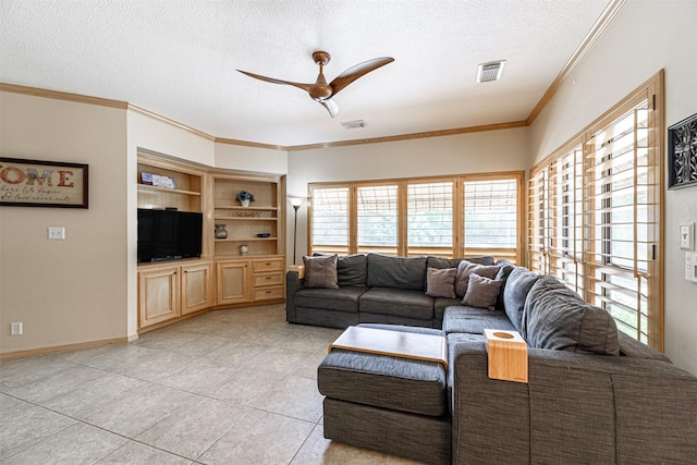 living room with ornamental molding, light tile patterned floors, ceiling fan, a textured ceiling, and built in shelves