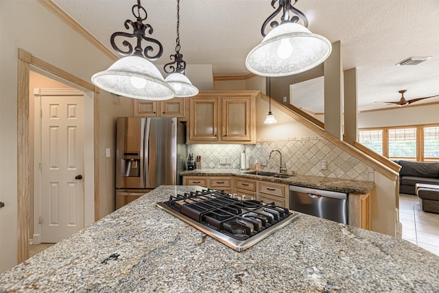 kitchen with sink, crown molding, backsplash, stainless steel appliances, and light stone counters