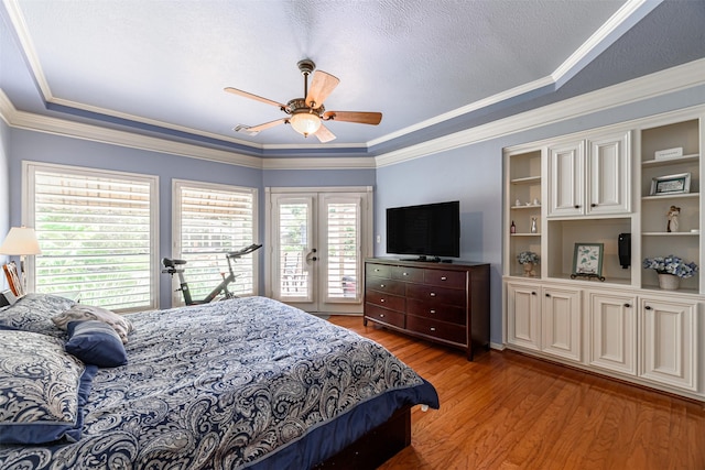 bedroom with french doors, ornamental molding, light hardwood / wood-style floors, and access to outside