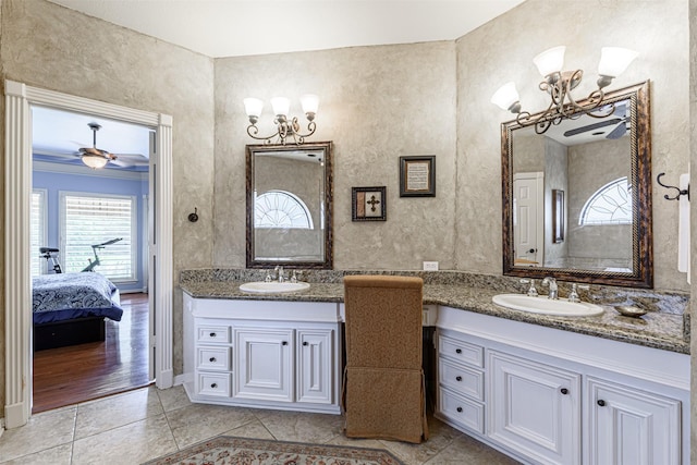 bathroom with vanity, ceiling fan with notable chandelier, and tile patterned floors